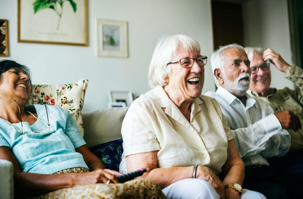 A happy group of seniors enjoys spending time together in their assisted living community.
