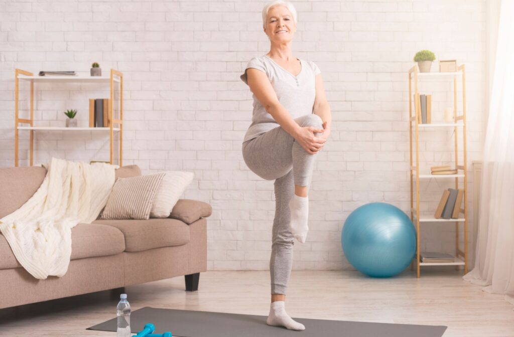 An active senior is doing a single-leg raise exercise to improve balance.