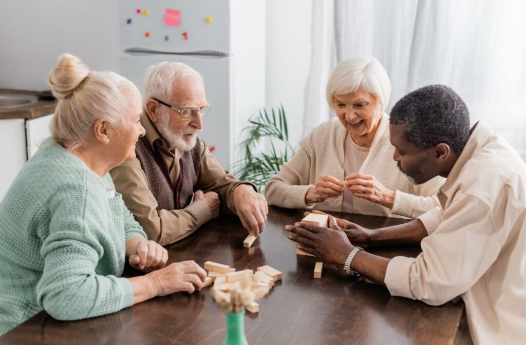 A group of senior friends play a game of Jenga together.